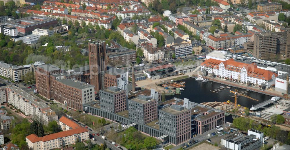 Berlin from the bird's eye view: Blick auf das neue Einkaufs-, Freizeit- und Kulturzentrum Tempelhofer Hafen in Berlin nahe dem Ullsteinhaus. Der Neubau wurde in das denkmalgeschützte Gebäude integriert. Die Architekten des Büros West 8 landscape architects sind für den neuen maritimen Flair in Tempelhof verantwortlich. Die IKB Deutsche Industriebank AG setzt das Projekt Tempelhofer Hafen gemeinsam mit der HLG Projektmanagement GmbH um. View the new shopping, leisure and cultural center in Berlin Tempelhof port near the house Ullstein. The new building was built into the listed building. The architects of the agency West 8 landscape architects are responsible for the new maritime flair in Tempelhof. The German industrial bank IKB AG is the project Tempelhof Harbour jointly by the HLG Projektmanagement GmbH.