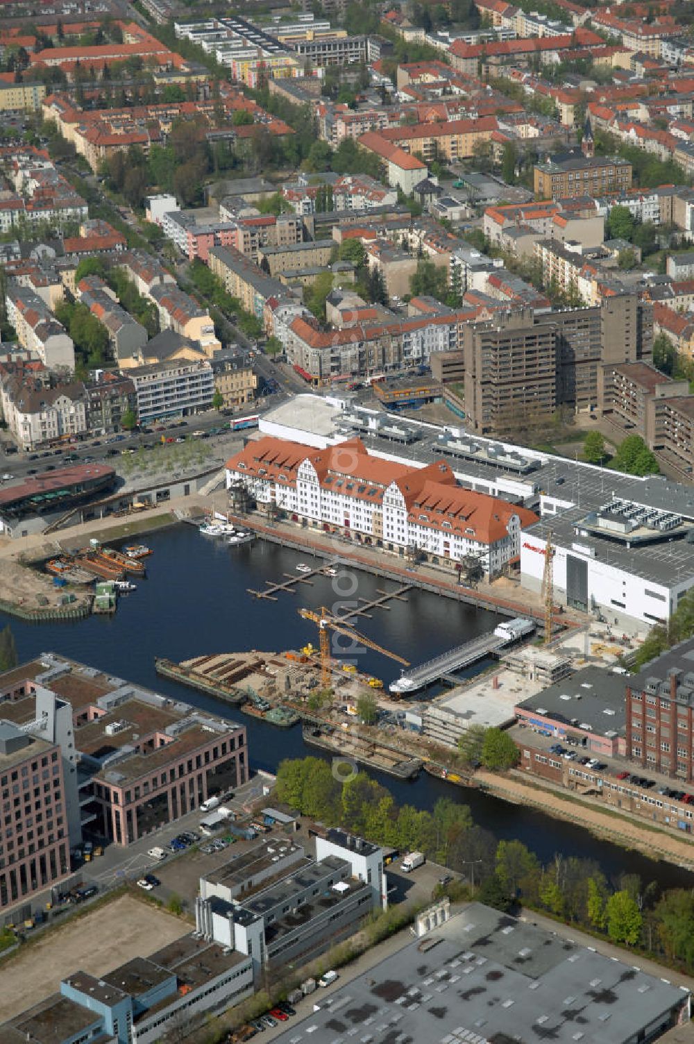 Aerial photograph Berlin - Blick auf das neue Einkaufs-, Freizeit- und Kulturzentrum Tempelhofer Hafen in Berlin nahe dem Ullsteinhaus. Der Neubau wurde in das denkmalgeschützte Gebäude integriert. Die Architekten des Büros West 8 landscape architects sind für den neuen maritimen Flair in Tempelhof verantwortlich. Die IKB Deutsche Industriebank AG setzt das Projekt Tempelhofer Hafen gemeinsam mit der HLG Projektmanagement GmbH um. View the new shopping, leisure and cultural center in Berlin Tempelhof port near the house Ullstein. The new building was built into the listed building. The architects of the agency West 8 landscape architects are responsible for the new maritime flair in Tempelhof. The German industrial bank IKB AG is the project Tempelhof Harbour jointly by the HLG Projektmanagement GmbH.