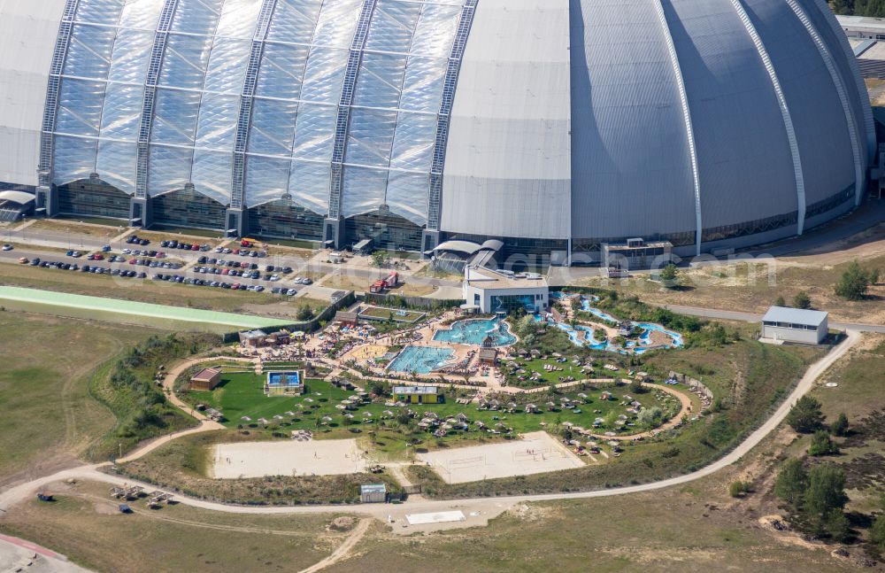 Krausnick from above - Complete complex of the Theme Park Tropical Islands with air hall, outdoor pool, campsite, holiday homes and former airfield on street Tropical-Islands-Allee in Krausnick in the state of Brandenburg, Germany