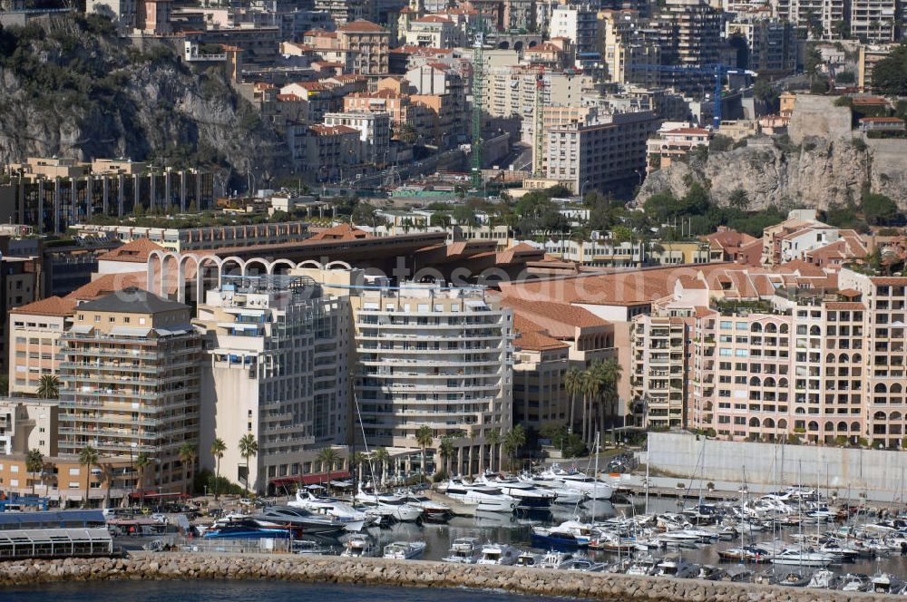 Aerial photograph Monaco - Blick auf das Fußballstadion Stade Louis II in Monaco. Das Stadion befindet sich im Stadtteil Fontvieille und wurde im Januar 1985 eröffnet. Die Besonderheit des Stadions ist, das sich das Spielfeld auf 8,5 Meter über der Straßenhöhe befindet, da es auf das viergeschossige Parkhaus gebaut wurde. Mit den großen Rundsäulen hinter den Toren ist die Architektur einzigartig. Das Stadion ist die Heimat des montegassischen Fußballvereins AS Monaco. Kontakt Verein: AS Monaco FC, Stade Louis II, BP698, 98014 Monaco Cedex, Tel. +377(0)9205 7473, Fax +377(0)9205 3688; Touistinfo: Administrative Information Centre, Avenue Albert II 23, MC 98000 Monaco, Tel. +377(0)9898 4026, Fax +377(0)9898 4086, Email: centre-info@gouv.mc