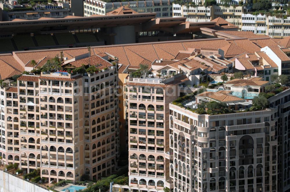 Aerial image Monaco - Blick auf das Fußballstadion Stade Louis II in Monaco. Das Stadion befindet sich im Stadtteil Fontvieille und wurde im Januar 1985 eröffnet. Die Besonderheit des Stadions ist, das sich das Spielfeld auf 8,5 Meter über der Straßenhöhe befindet, da es auf das viergeschossige Parkhaus gebaut wurde. Mit den großen Rundsäulen hinter den Toren ist die Architektur einzigartig. Das Stadion ist die Heimat des montegassischen Fußballvereins AS Monaco. Kontakt Verein: AS Monaco FC, Stade Louis II, BP698, 98014 Monaco Cedex, Tel. +377(0)9205 7473, Fax +377(0)9205 3688; Touistinfo: Administrative Information Centre, Avenue Albert II 23, MC 98000 Monaco, Tel. +377(0)9898 4026, Fax +377(0)9898 4086, Email: centre-info@gouv.mc