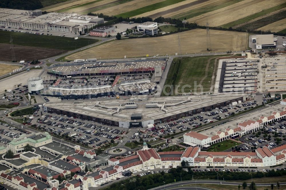 Parndorf from above - Building of the shopping center Parndorf Fashion Outlet on the Gewerbestrasse in Parndorf in Burgenland, Austria