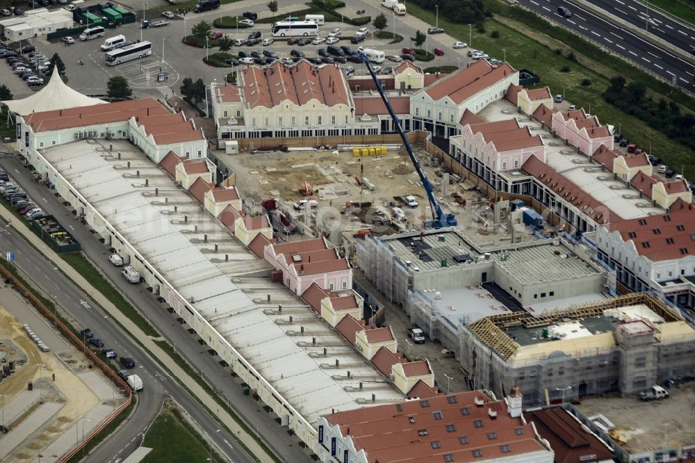 Parndorf from above - Building of the shopping center Parndorf Fashion Outlet on the Gewerbestrasse in Parndorf in Burgenland, Austria