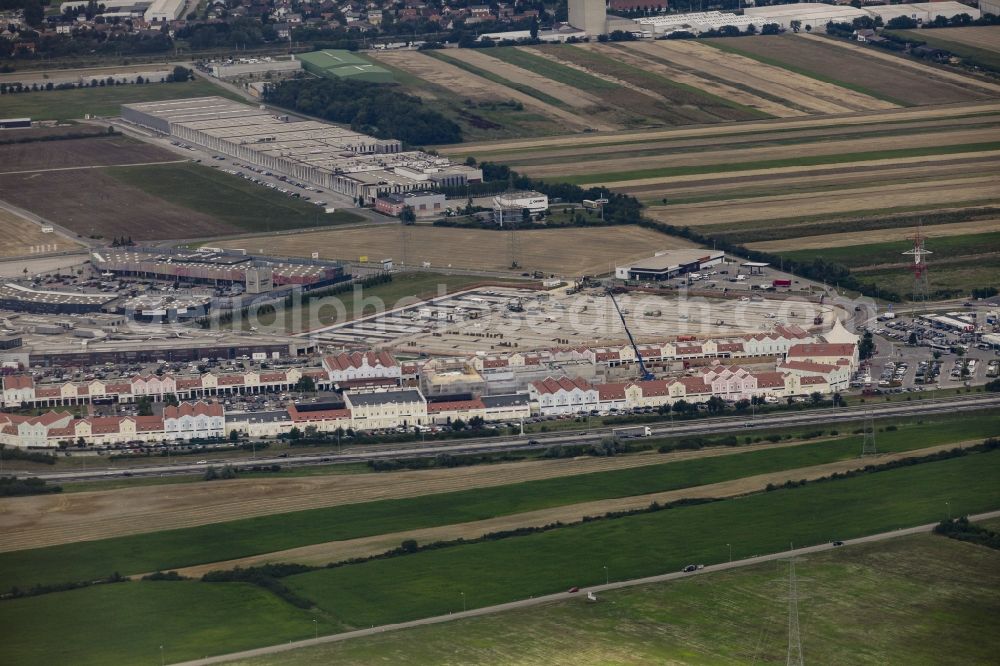 Aerial image Parndorf - Building of the shopping center Parndorf Fashion Outlet on the Gewerbestrasse in Parndorf in Burgenland, Austria