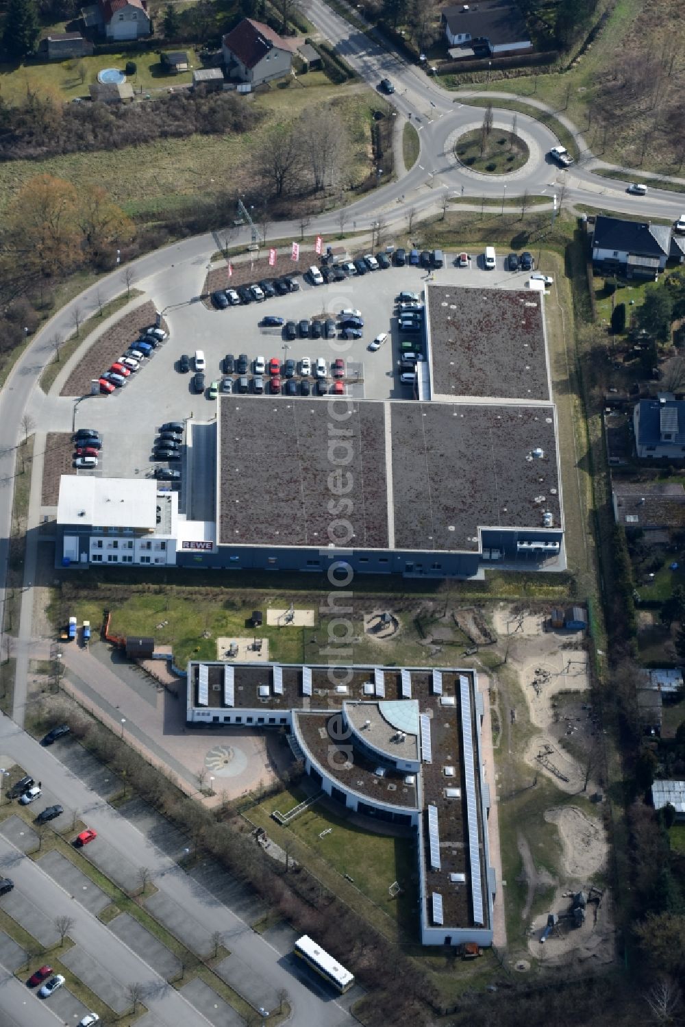 Aerial image Fredersdorf-Vogelsdorf - Building of the shopping center REWE and DM Drogerie on Brueckenstrasse in Fredersdorf-Vogelsdorf in the state Brandenburg