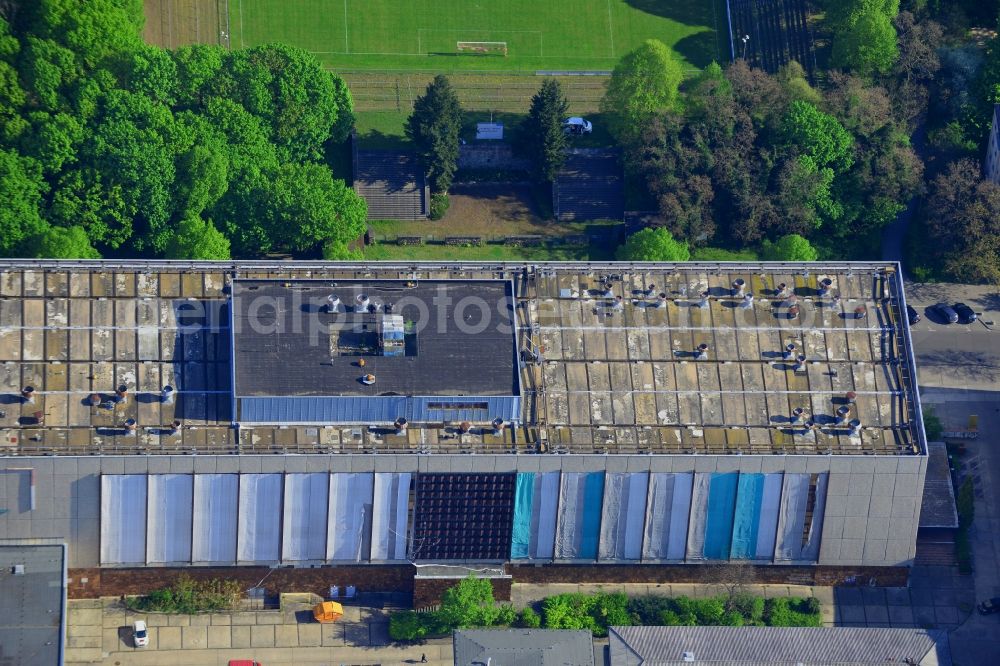 Aerial image Berlin - Building on the compound of the research and memorial site Normannenstrasse in the Lichtenberg district of Berlin in Germany. The distinct building opposite a football pitch is connected to the former Stasi headquarters (Ministry for state security)