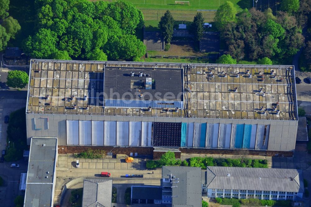 Aerial photograph Berlin - Building on the compound of the research and memorial site Normannenstrasse in the Lichtenberg district of Berlin in Germany. The distinct building opposite a football pitch is connected to the former Stasi headquarters (Ministry for state security)