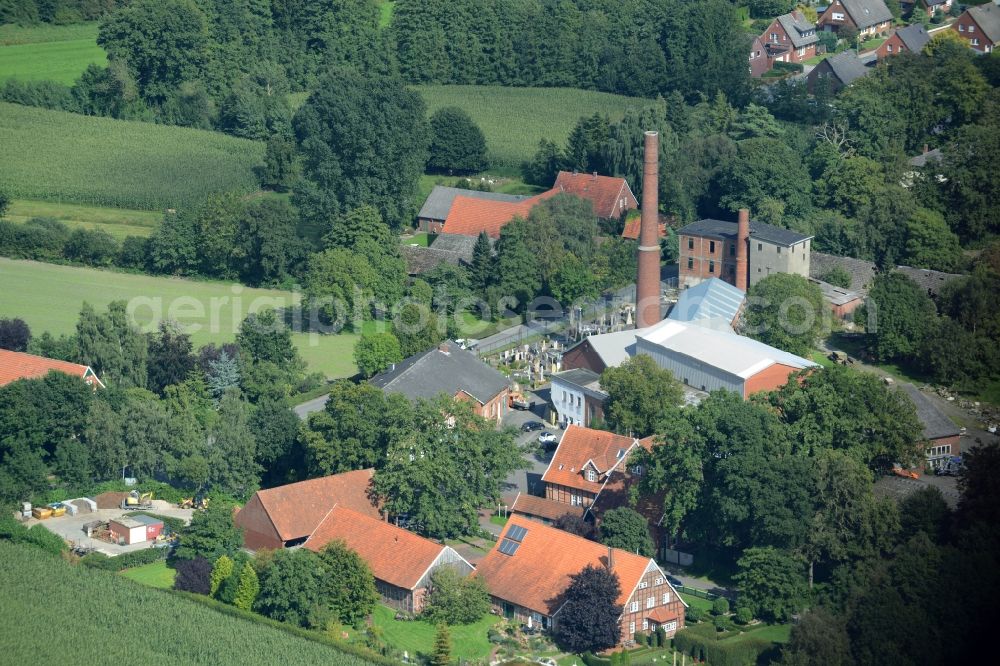 Aerial photograph Poggenort - View on the hotel building Alte Kornbrennerei and the family business Natursteine Heinz Stall in Poggenort in the state Lower Saxony