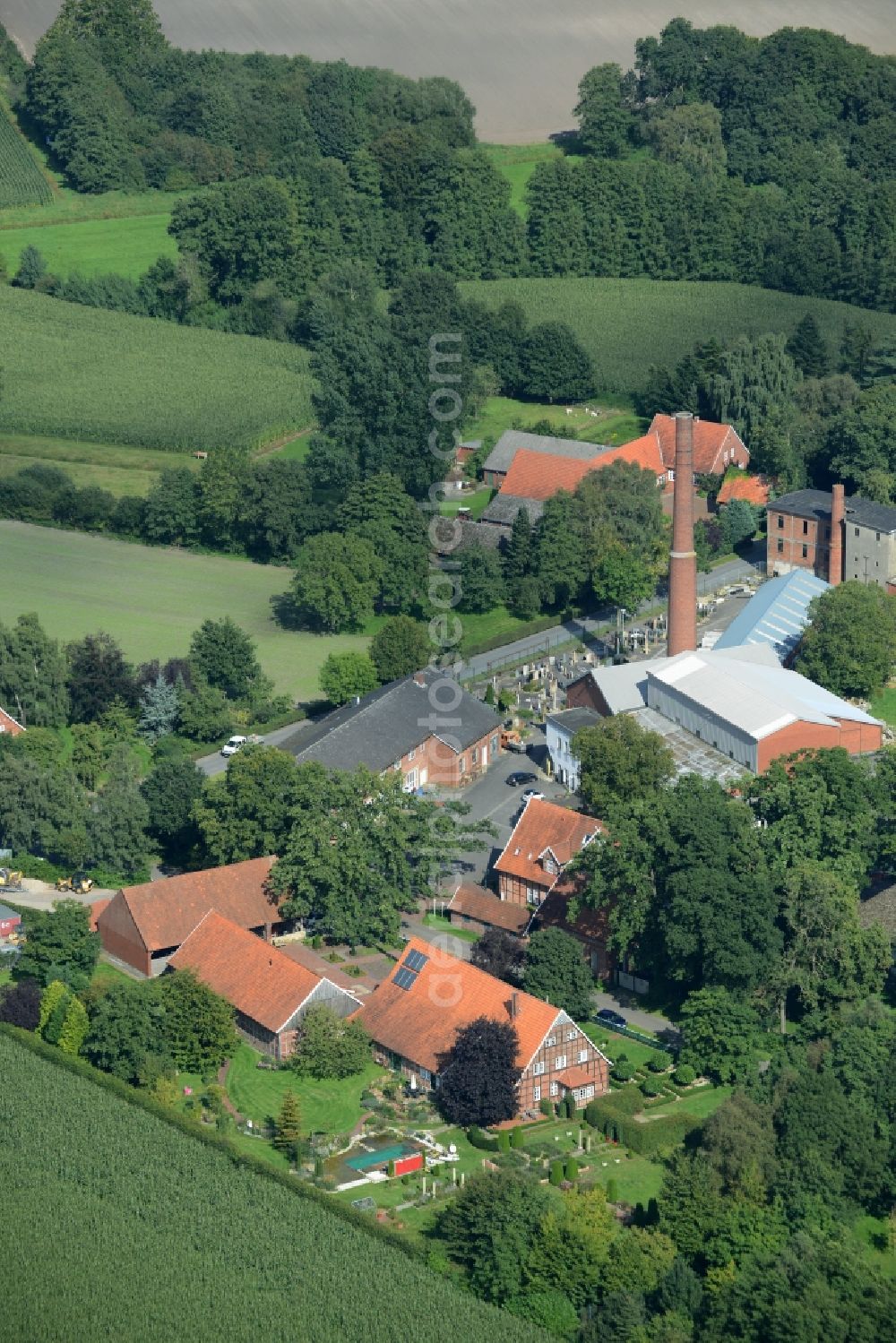 Poggenort from above - View on the hotel building Alte Kornbrennerei and the family business Natursteine Heinz Stall in Poggenort in the state Lower Saxony