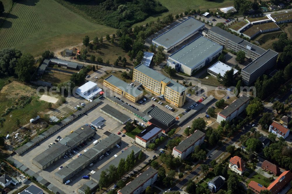 Hoppegarten from above - Building of the state office for building and traffic in Hoppegarten in the state of Brandenburg. The administrative offices in the building with the yellow facade are sitting amidst residential and commercial buildings on the Southwestern edge of Hoppegarten