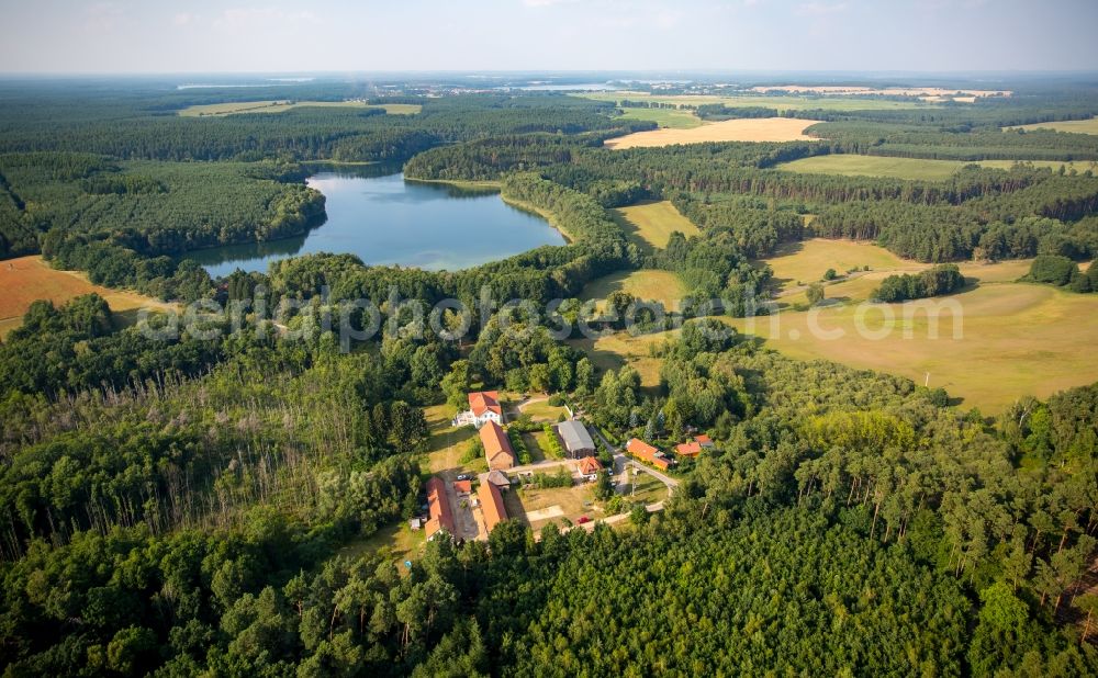 Neu-Drosedow from above - Buildings and park of the farmhouse mansion Gut Drosedow in Neu-Drosedow in the state of Mecklenburg - Western Pomerania. Lake Peetschsee is located in the background, surrounded by forest