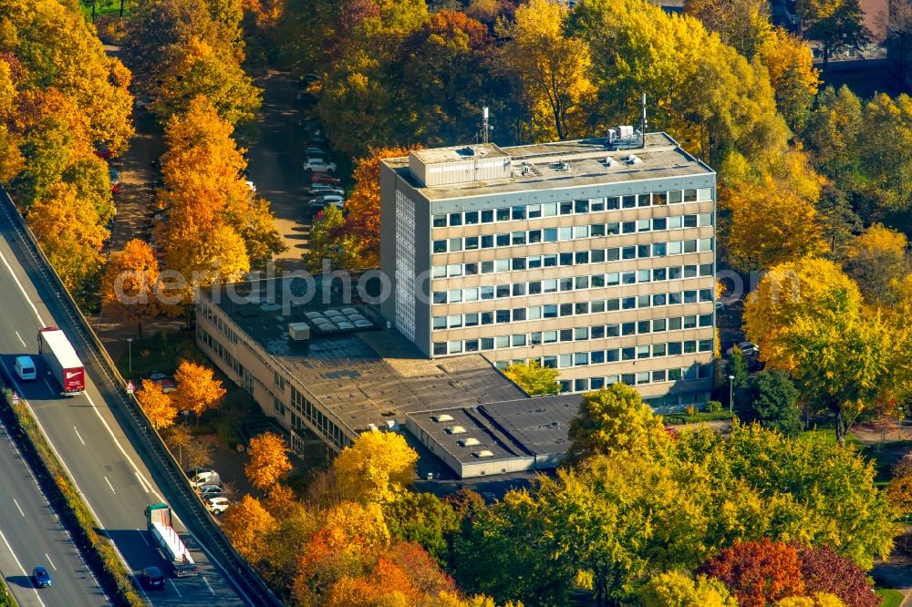 Arnsberg from the bird's eye view: Town Hall building of the city administration in Arnsberg in the state North Rhine-Westphalia. The building with the Job center is located in a colourful autumnal forest on federal motorway A 46