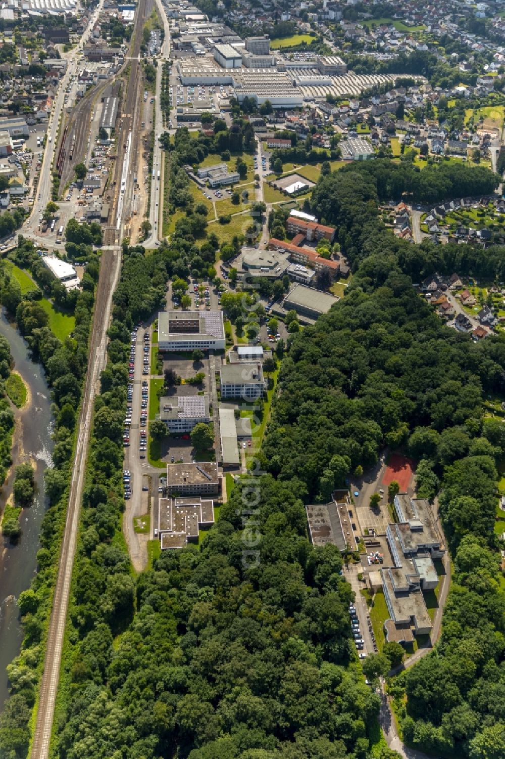 Arnsberg from the bird's eye view: Building complex of the Vocational School Berufskolleg f. Wirtschaft u. Verwaltung HSK entlong on Schienengleisen in Arnsberg in the state North Rhine-Westphalia, Germany