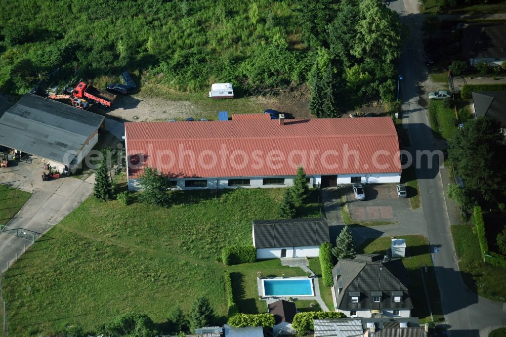 Bernau from the bird's eye view: Building complex and grounds of the automotive repair shop Wilhelm-Weitling-Strasse in Bernau in the state Brandenburg