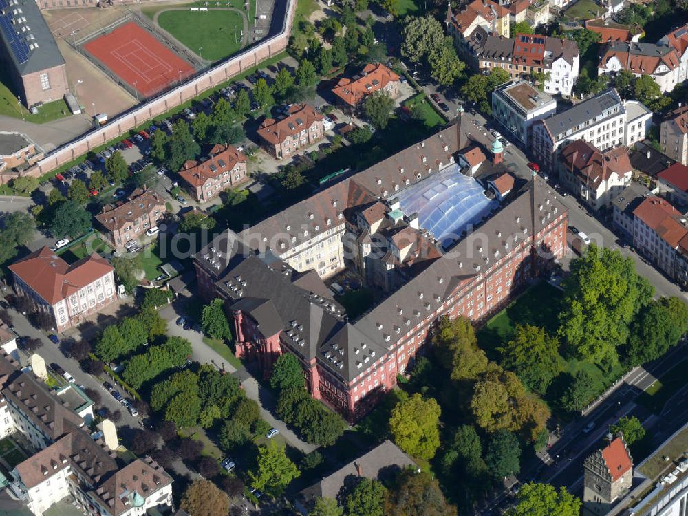 Aerial photograph Freiburg im Breisgau - Gebäudekomplex vom Herder Verlag, auch Rotes Haus genannt, im Stadtteil Neuburg von Freiburg, Baden-Württemberg. Ein großer Teil des Verlagsgebäudes wurde verkauft und steht der Universität Freiburg zur Verfügung welche die Räumlichkeiten für die Unterbringung der Institute für Forst- und Umweltwissenschaften und als Ausstellungsstätte für ihre archäologischen Sammlungen nutzt. Building complex of the publisher Herder, also called red house, in the district Neuburg in Freiburg, Baden-Wuerttemberg. Also a big part of the complex is used by the university Freiburg.