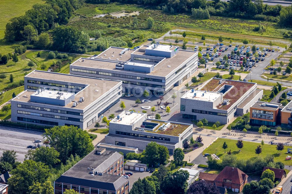 Lippstadt from above - Building complex of the university Hochschule Hamm-Lippstadt overlooking the construction site for the Digital Innovation Campus at the Campus Lippstadt on Dr.-Arnold-Hueck-Strasse in Lippstadt in the state North Rhine-Westphalia, Germany