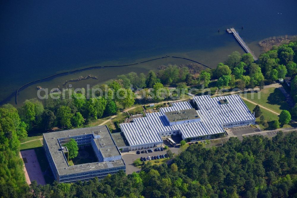 Aerial image Berlin - Complex of the hotel building Hotel Mueggelsee in Berlin in Germany. The hotel is located on the shores of the lake in the nature protection area of Koepenick and consists of a square building and a park