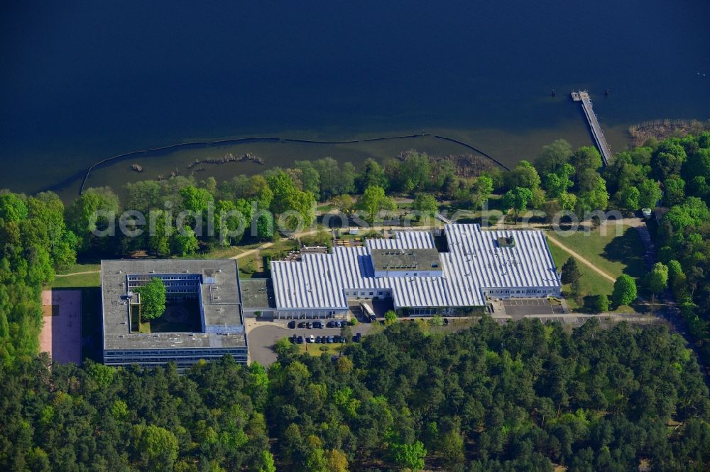 Aerial photograph Berlin - Complex of the hotel building Hotel Mueggelsee in Berlin in Germany. The hotel is located on the shores of the lake in the nature protection area of Koepenick and consists of a square building and a park