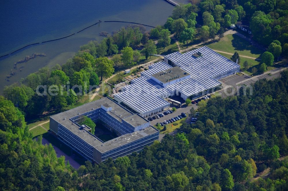 Berlin from above - Complex of the hotel building Hotel Mueggelsee in Berlin in Germany. The hotel is located on the shores of the lake in the nature protection area of Koepenick and consists of a square building and a park