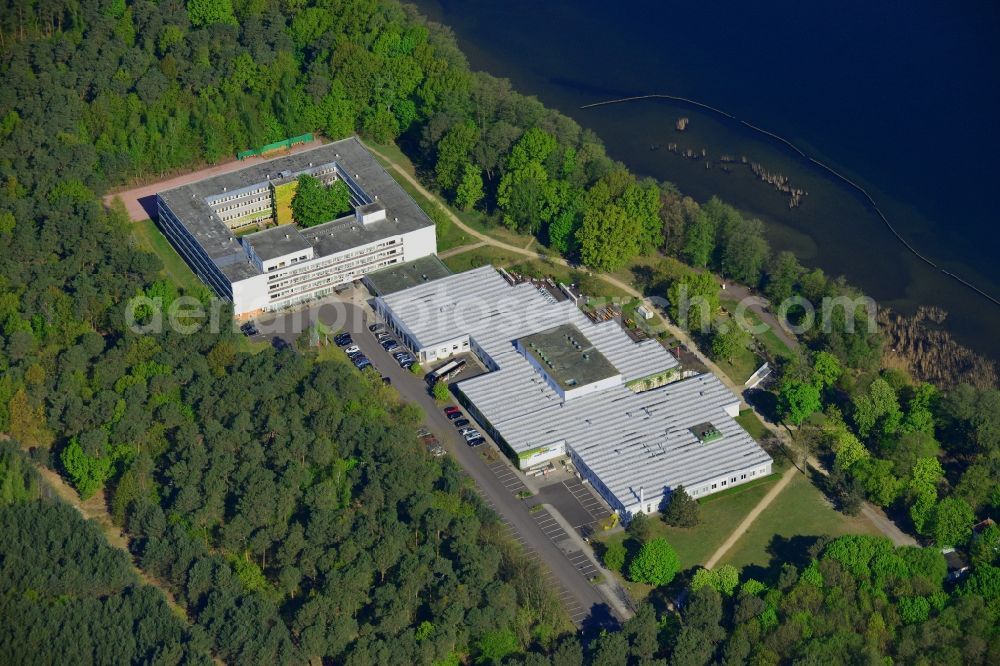 Berlin from above - Complex of the hotel building Hotel Mueggelsee in Berlin in Germany. The hotel is located on the shores of the lake in the nature protection area of Koepenick and consists of a square building and a park