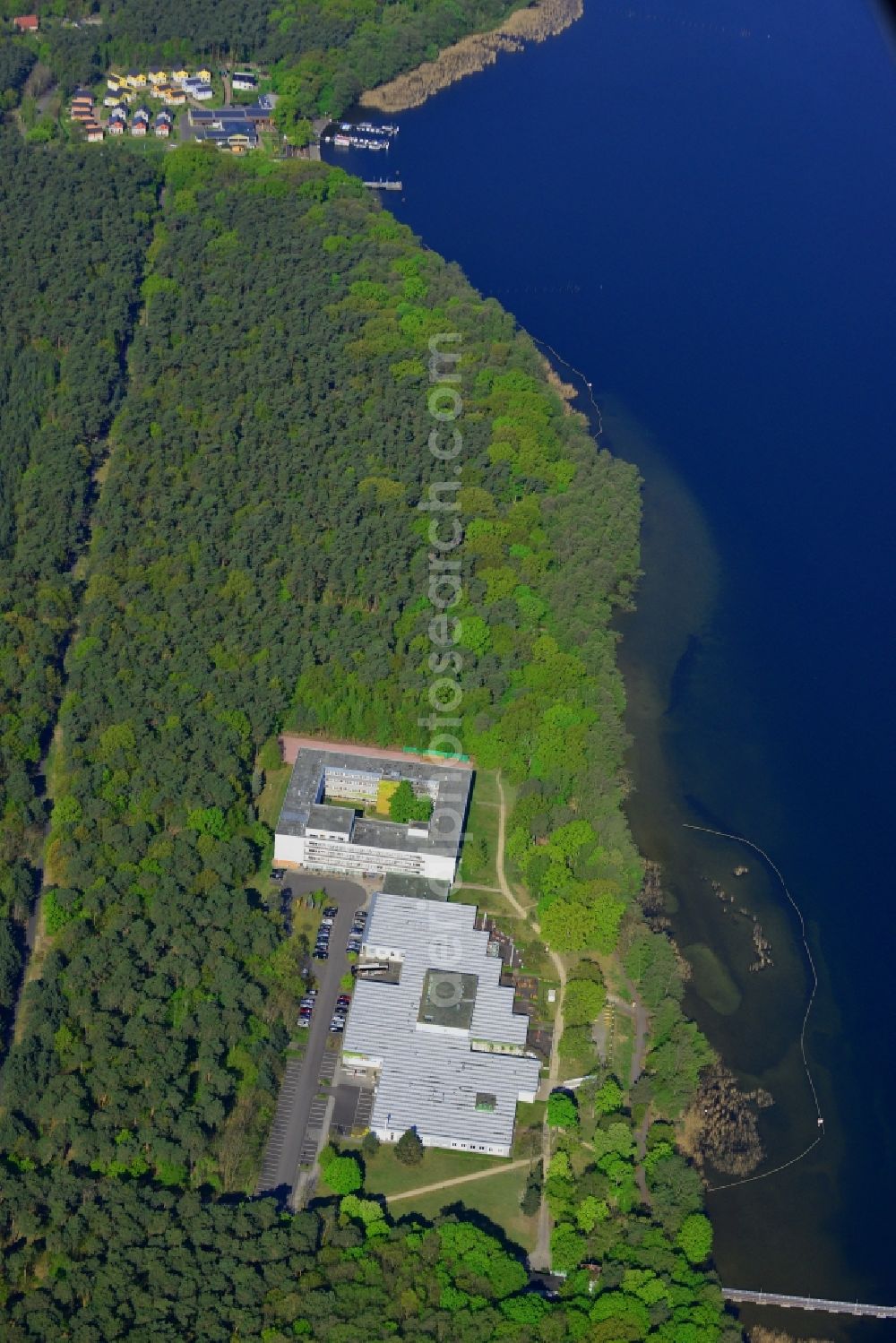 Aerial image Berlin - Complex of the hotel building Hotel Mueggelsee in Berlin in Germany. The hotel is located on the shores of the lake in the nature protection area of Koepenick and consists of a square building and a park