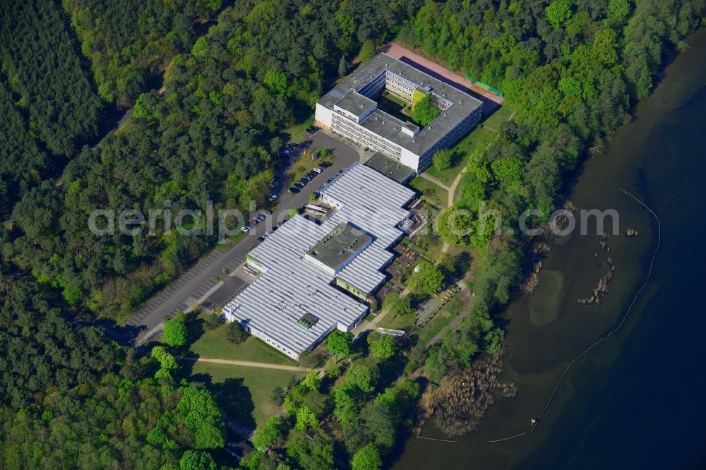 Berlin from above - Complex of the hotel building Hotel Mueggelsee in Berlin in Germany. The hotel is located on the shores of the lake in the nature protection area of Koepenick and consists of a square building and a park