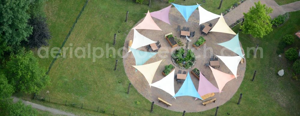 Templin from above - With colorful pennants - chain decorated outdoor terrace on complex of the hotel building Landsitz-Hotel in Templin in the state Brandenburg