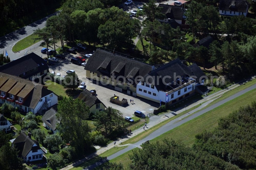 Aerial photograph Wustrow - Complex of the hotel building Ostseehotel Wustrow in the South of Wustrow in the state of Mecklenburg - Western Pomerania. The compound of the beach hotel is surrounded by trees and forest and is located on bicycle road