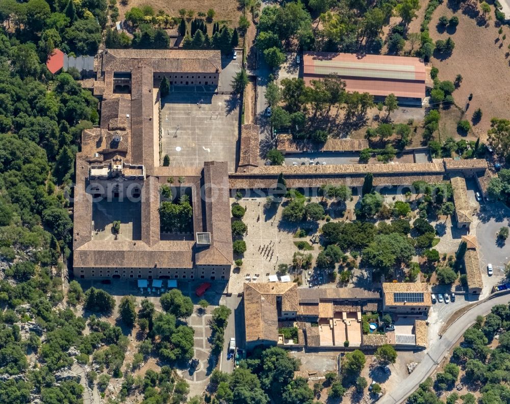 Aerial image Escorca - Complex of buildings of the monastery Santuari de Lluc in Escorca at Serra de Tramuntana in Balearic island of Mallorca, Spain