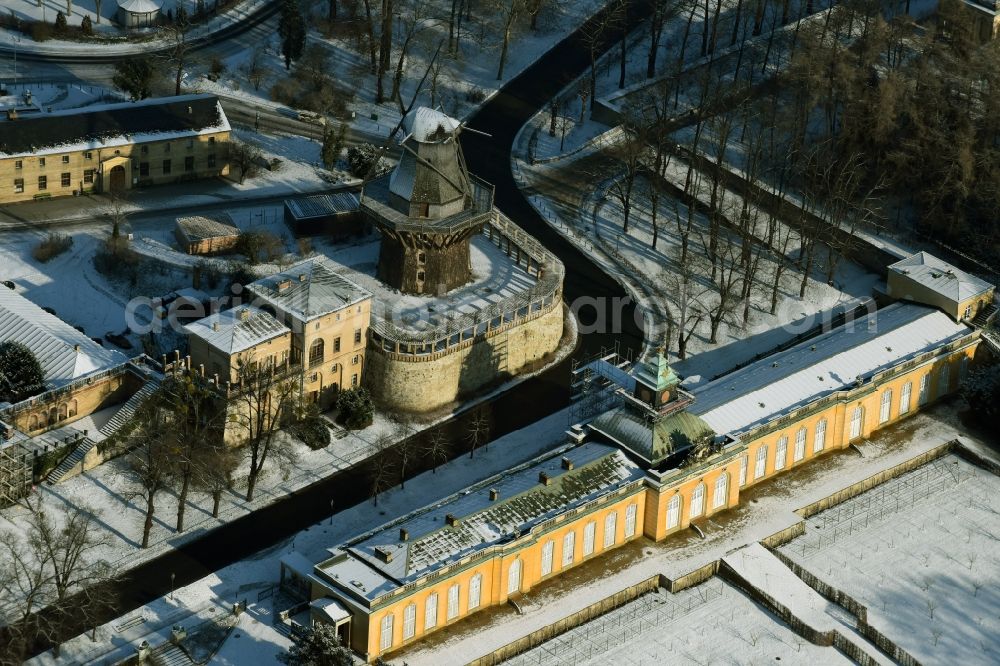 Potsdam from above - Building complex of the New Chambers and the Historic Mill in the snow covered Sanssouci park in Potsdam in the state of Brandenburg