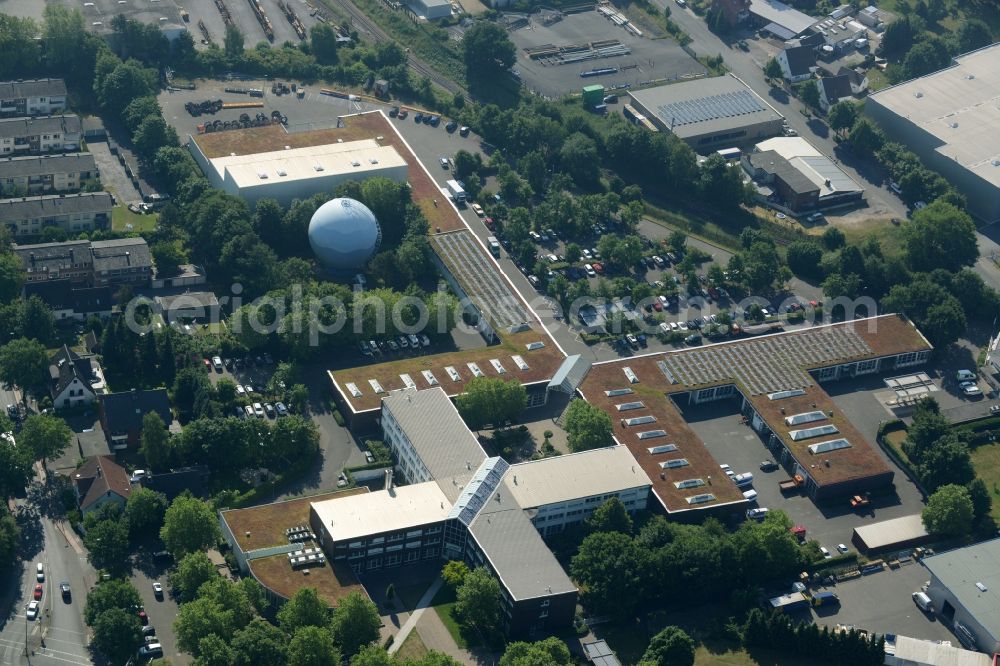 Aerial photograph Gütersloh - Building complex of the public services in the Nordhorn part of Guetersloh in the state of North Rhine-Westphalia. The compound includes a distinct cross-shaped building and a blue spherical gas tank