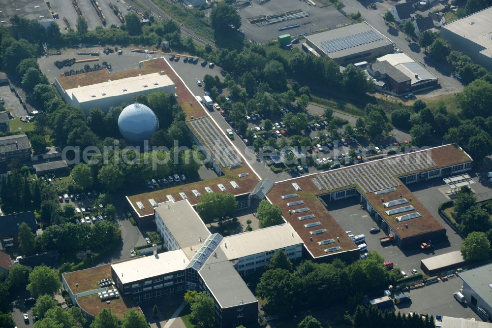 Gütersloh from above - Building complex of the public services in the Nordhorn part of Guetersloh in the state of North Rhine-Westphalia. The compound includes a distinct cross-shaped building and a blue spherical gas tank