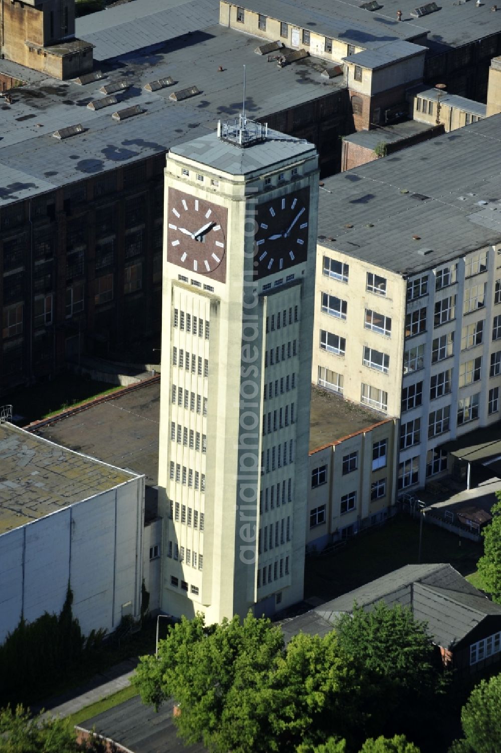 Wittenberge from above - View of the abandoned buildings of the former Veritas at the Bad Wilsnacker street in Wittenberg in the state of Brandenburg. After the dismantling of the singer-plant production under the name Veritas was continued. The clock tower of the former Singer sewing machine factory / Veritas in Wittenberg Germany is the largest and second largest clock tower in Europe