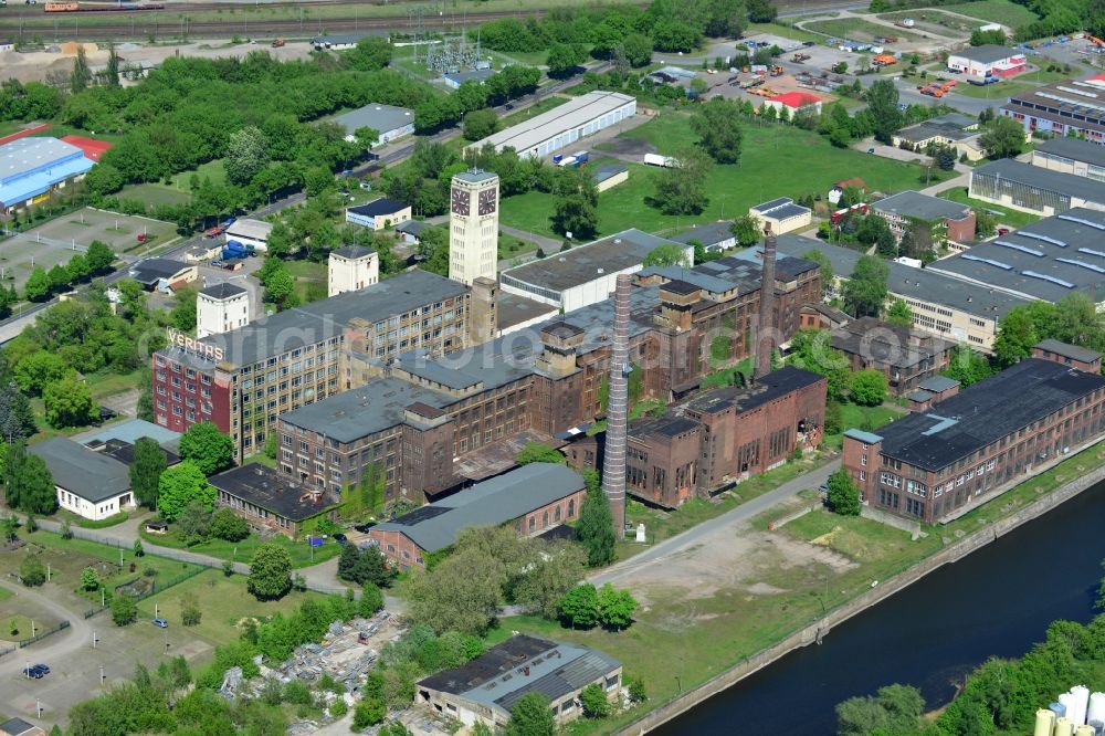 Wittenberge from the bird's eye view: View of the abandoned buildings of the former Veritas at the Bad Wilsnacker street in Wittenberg in the state of Brandenburg. After the dismantling of the singer-plant production under the name Veritas was continued. The clock tower of the former Singer sewing machine factory / Veritas in Wittenberg Germany is the largest and second largest clock tower in Europe