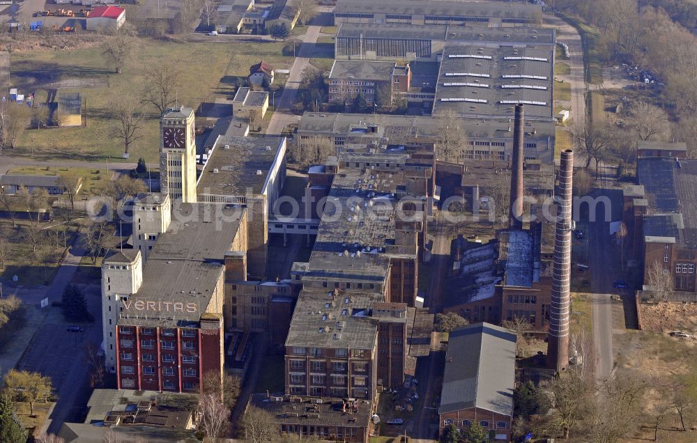 Wittenberge from above - View of the abandoned buildings of the former Veritas at the Bad Wilsnacker street in Wittenberg in the state of Brandenburg. After the dismantling of the singer-plant production under the name Veritas was continued. The clock tower of the former Singer sewing machine factory / Veritas in Wittenberg Germany is the largest and second largest clock tower in Europe