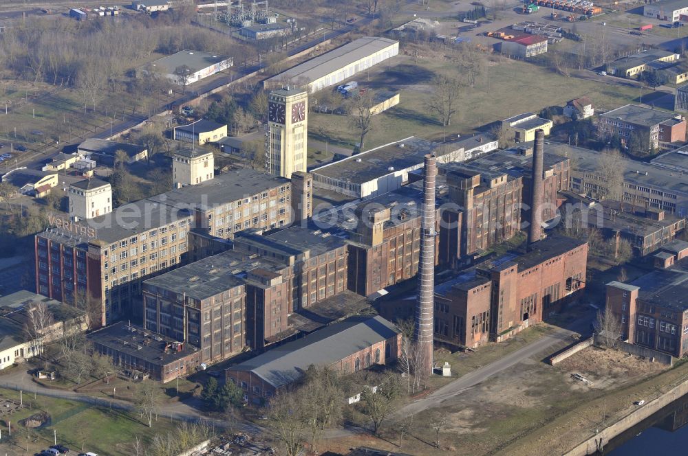 Aerial image Wittenberge - View of the abandoned buildings of the former Veritas at the Bad Wilsnacker street in Wittenberg in the state of Brandenburg. After the dismantling of the singer-plant production under the name Veritas was continued. The clock tower of the former Singer sewing machine factory / Veritas in Wittenberg Germany is the largest and second largest clock tower in Europe