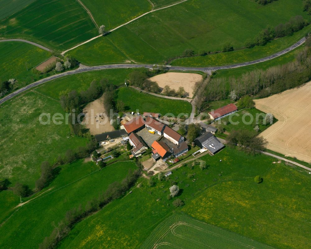 Aerial photograph Arnshain - Homestead and farm outbuildings on the edge of agricultural fields in Arnshain in the state Hesse, Germany