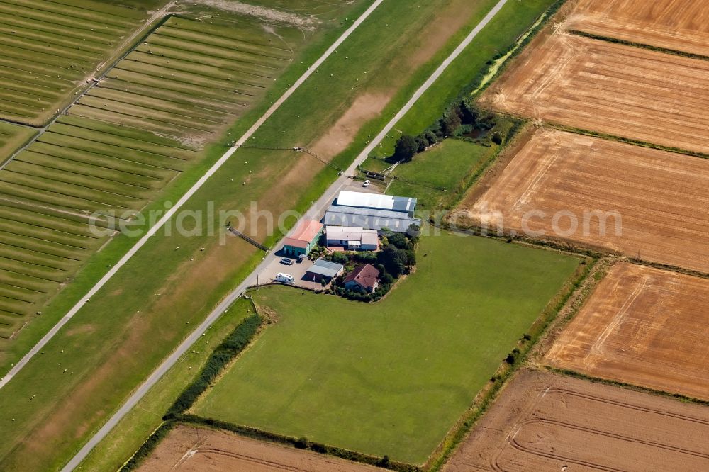 Aerial photograph Nordstrand - Homestead and farm outbuildings on the edge of agricultural fields with Hofladen on street Pohnshalligkoogstrasse in Nordstrand North Friesland in the state Schleswig-Holstein, Germany
