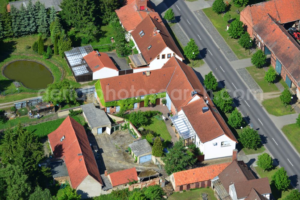 Wohlenberg from the bird's eye view: Homestead and farm outbuildings on the edge of agricultural fields on street L9 in Wohlenberg in the Altmark in the state Saxony-Anhalt, Germany