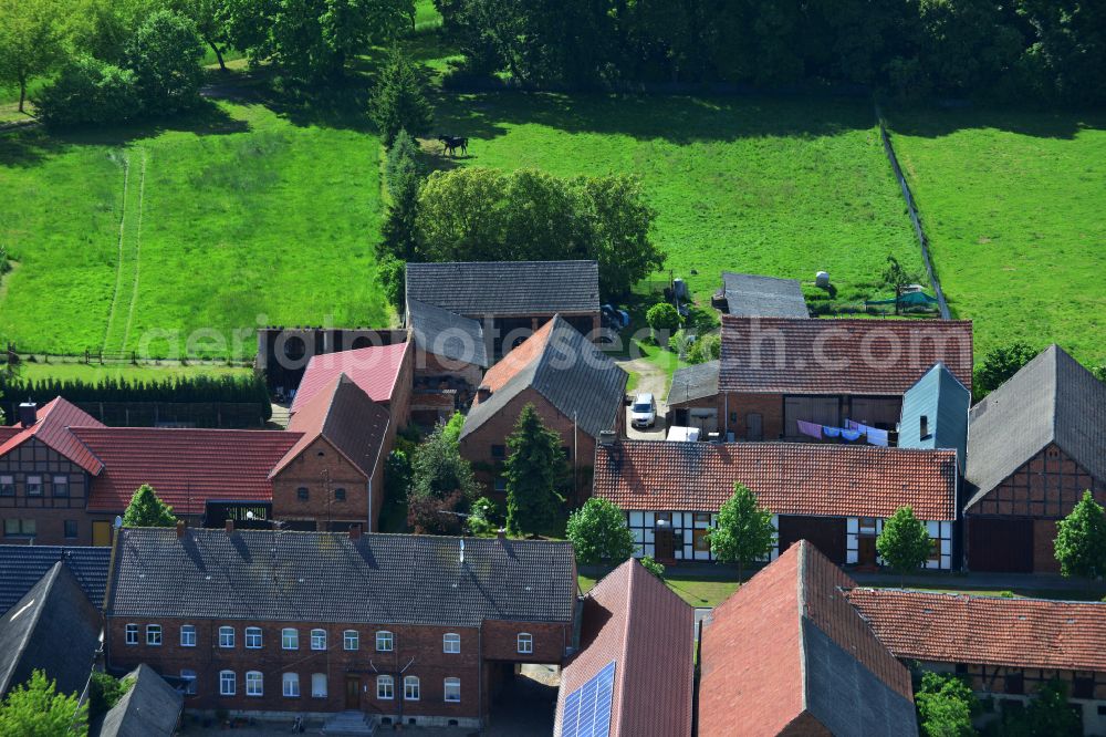 Wohlenberg from the bird's eye view: Homestead and farm outbuildings on the edge of agricultural fields on street L9 in Wohlenberg in the Altmark in the state Saxony-Anhalt, Germany