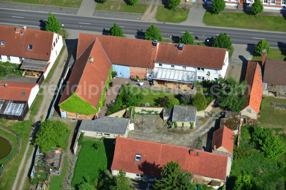 Wohlenberg from the bird's eye view: Homestead and farm outbuildings on the edge of agricultural fields on street L9 in Wohlenberg in the Altmark in the state Saxony-Anhalt, Germany