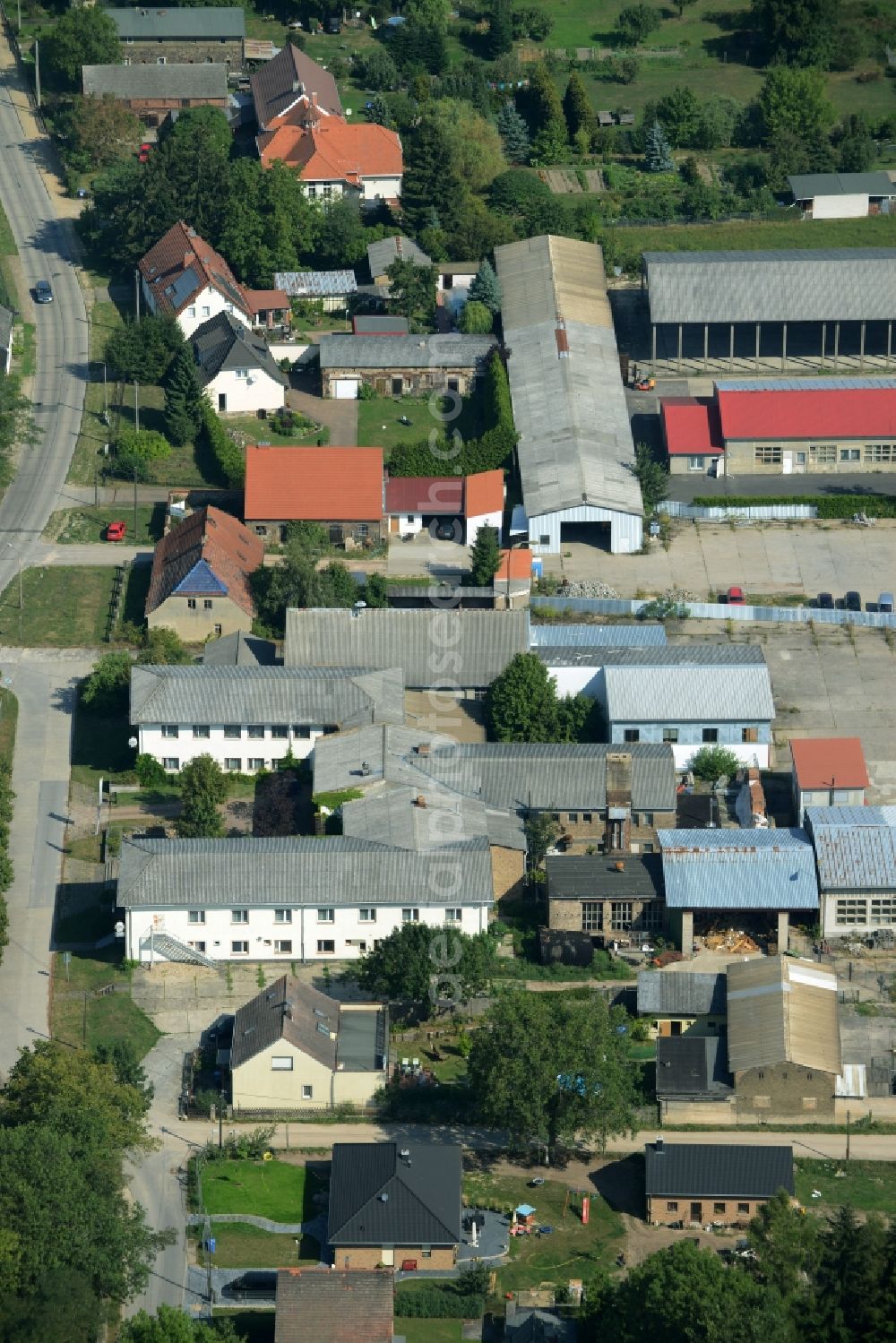 Rehfelde from the bird's eye view: Farm and agricultural estate on Lagerstrasse in the South of Rehfelde in the state of Brandenburg. The compound includes outbuildings, stables and residential buildings