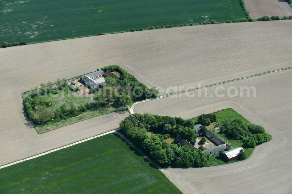 Aakirkeby from the bird's eye view: Farm on the edge of cultivated fields in Aakirkeby Bornholm Island in Region Hovedstaden, Denmark