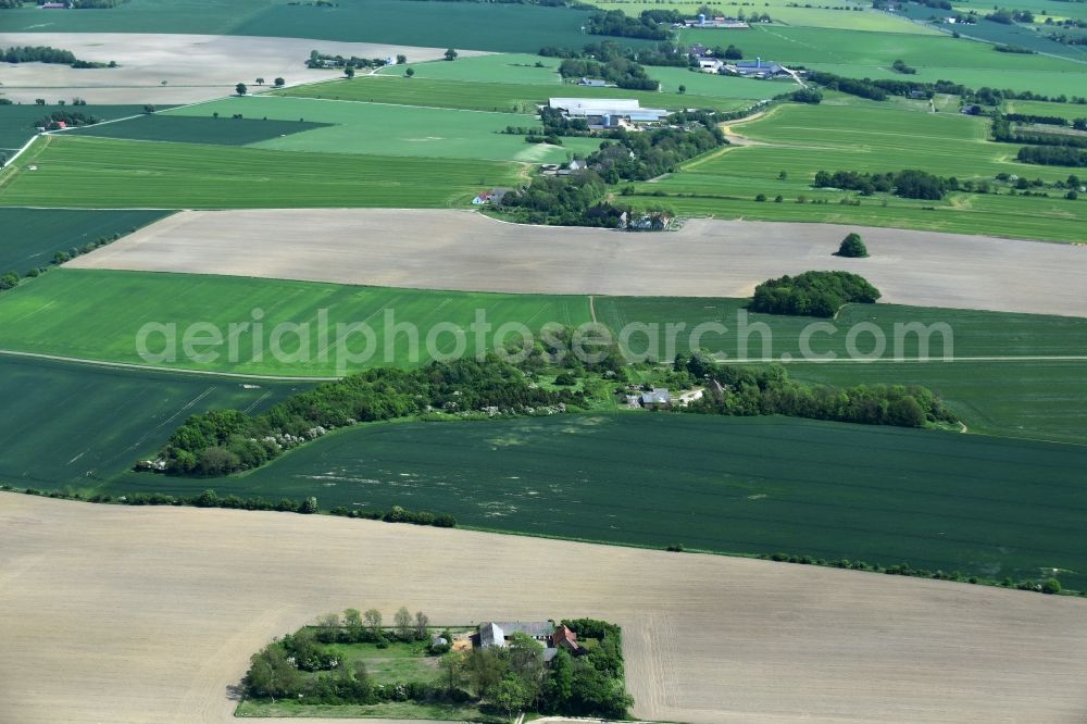 Aakirkeby from the bird's eye view: Farm on the edge of cultivated fields in Aakirkeby Bornholm Island in Region Hovedstaden, Denmark