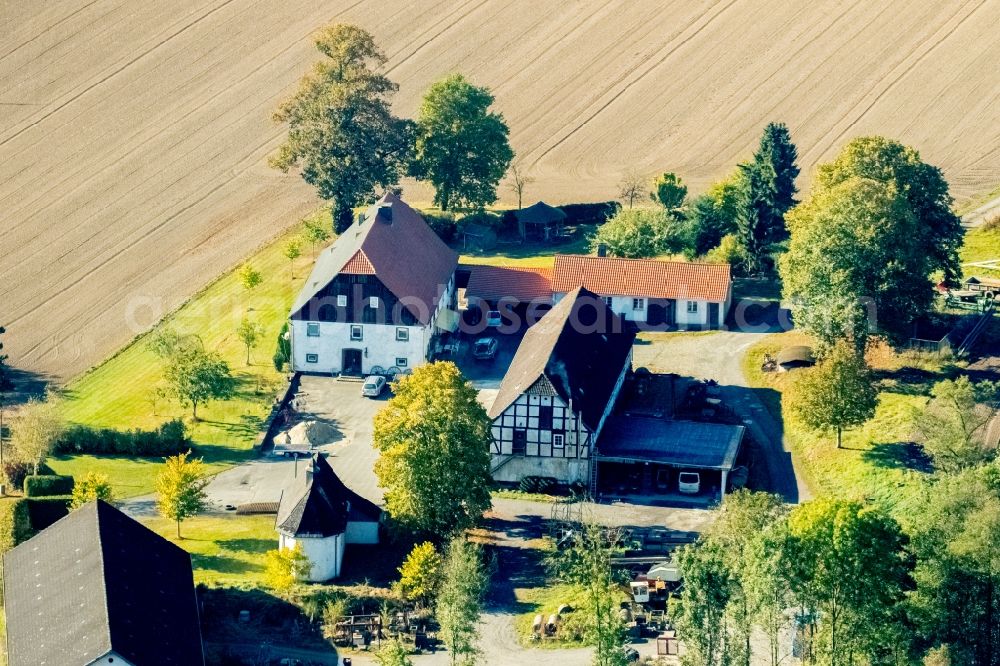 Meschede from the bird's eye view: Farm on the edge of cultivated fields in Meschede in the state North Rhine-Westphalia