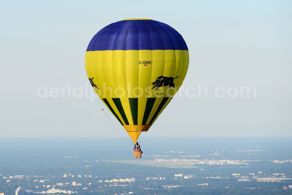 Jork from above - A yellow- blue coloured hot-air balloon with the identifier D-ORMC in flight above Jork in the state Lower Saxony