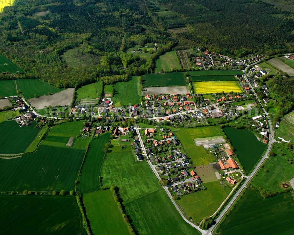 Aerial image Bliestorf - Yellow - green contrast of blooming rapeseed flowers on field stripes in Bliestorf in the state Schleswig-Holstein, Germany