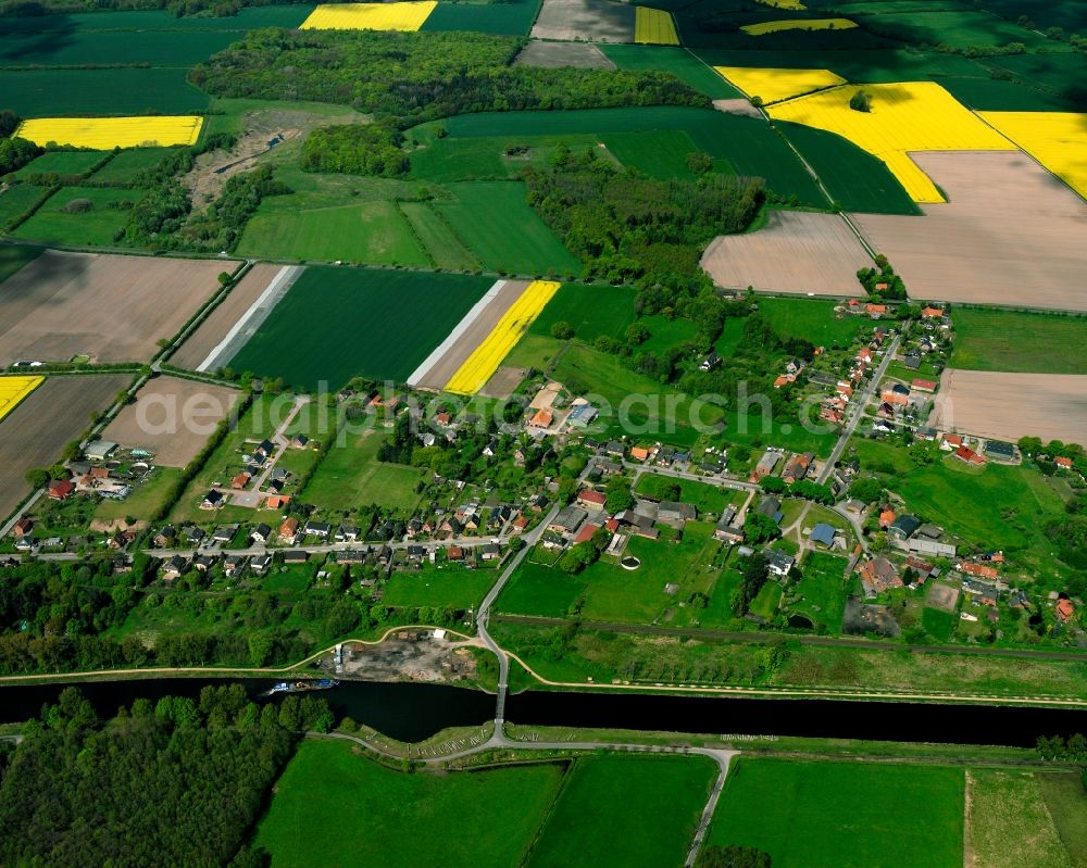 Dalldorf from above - Yellow - green contrast of blooming rapeseed flowers on field stripes in Dalldorf in the state Schleswig-Holstein, Germany