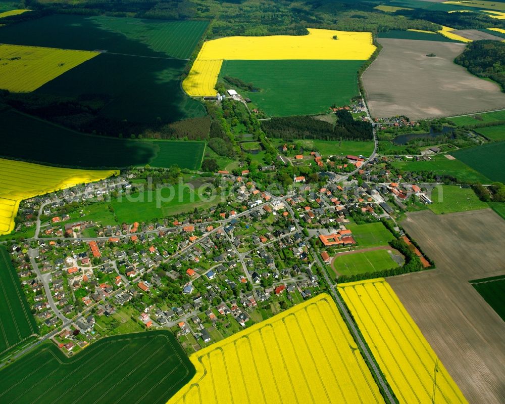 Gülzow from above - Yellow - green contrast of blooming rapeseed flowers on field stripes in Gülzow in the state Schleswig-Holstein, Germany