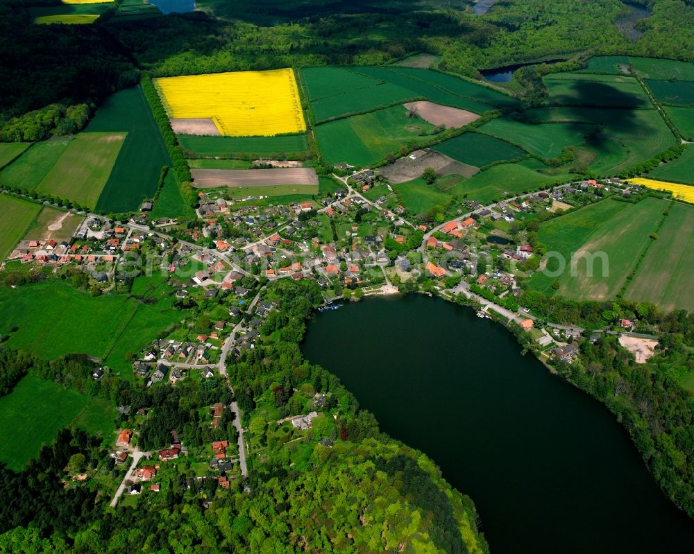 Aerial image Kogel Siedlung - Yellow - green contrast of blooming rapeseed flowers on field stripes in Kogel Siedlung in the state Schleswig-Holstein, Germany